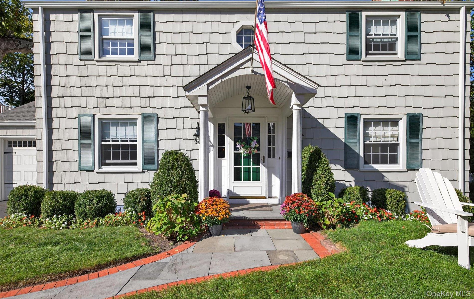 53 Eakins Road Manhasset, NY 11030 - Photo 3 of 34 a front view of a house with garden