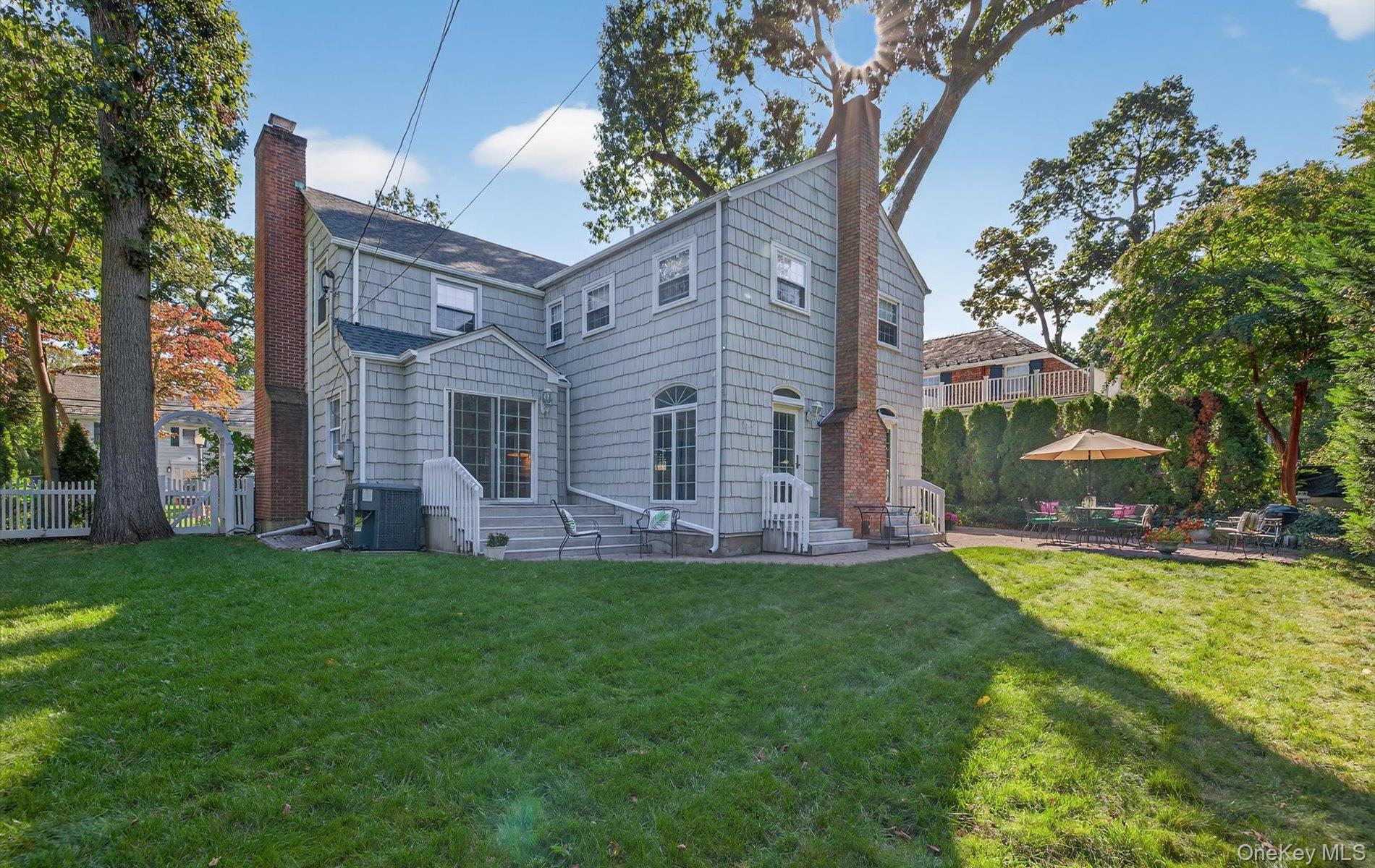 53 Eakins Road Manhasset, NY 11030 - Photo 32 of 34 a view of a house with a yard