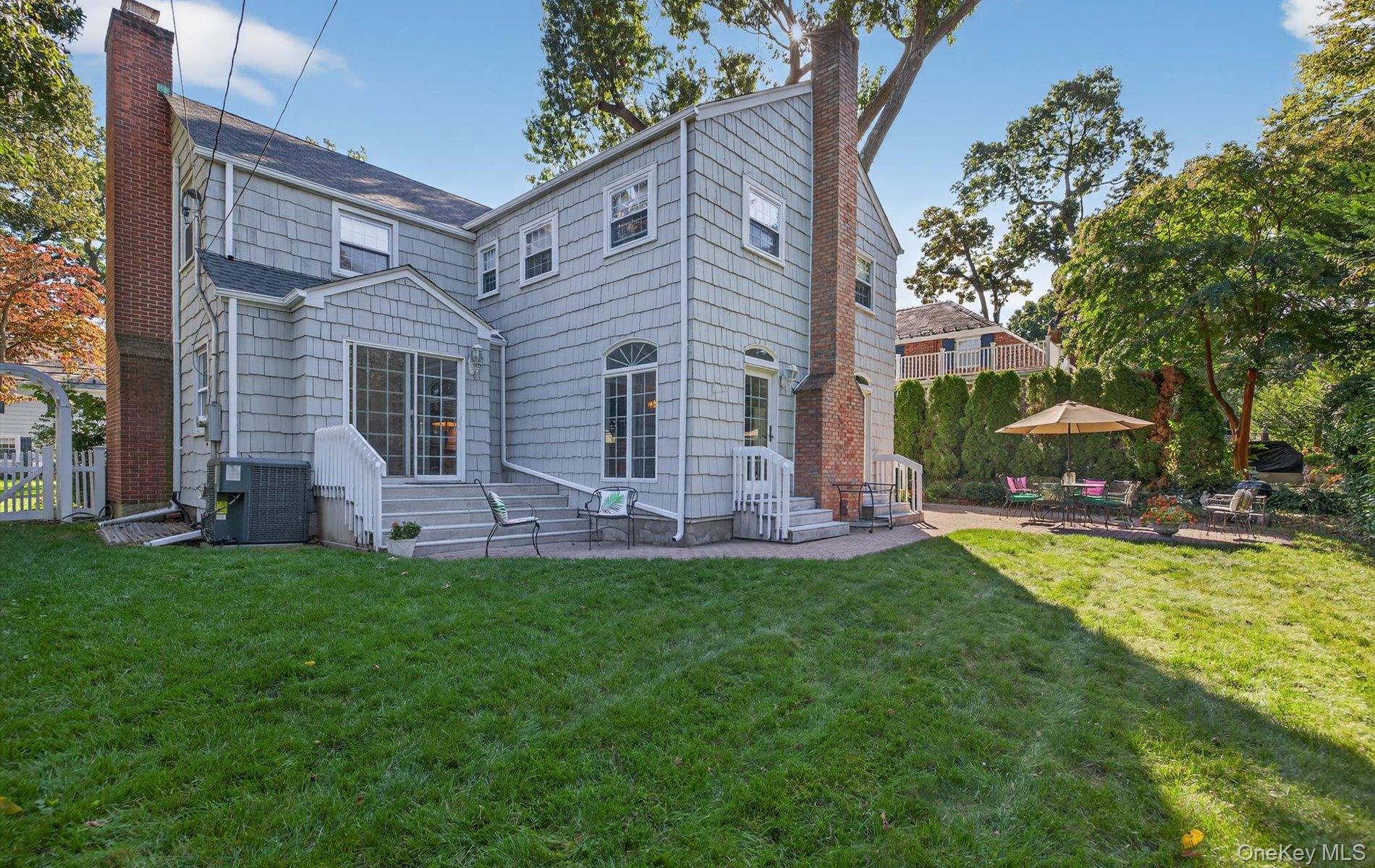 53 Eakins Road Manhasset, NY 11030 - Photo 33 of 34 a view of a house with a yard porch and sitting area