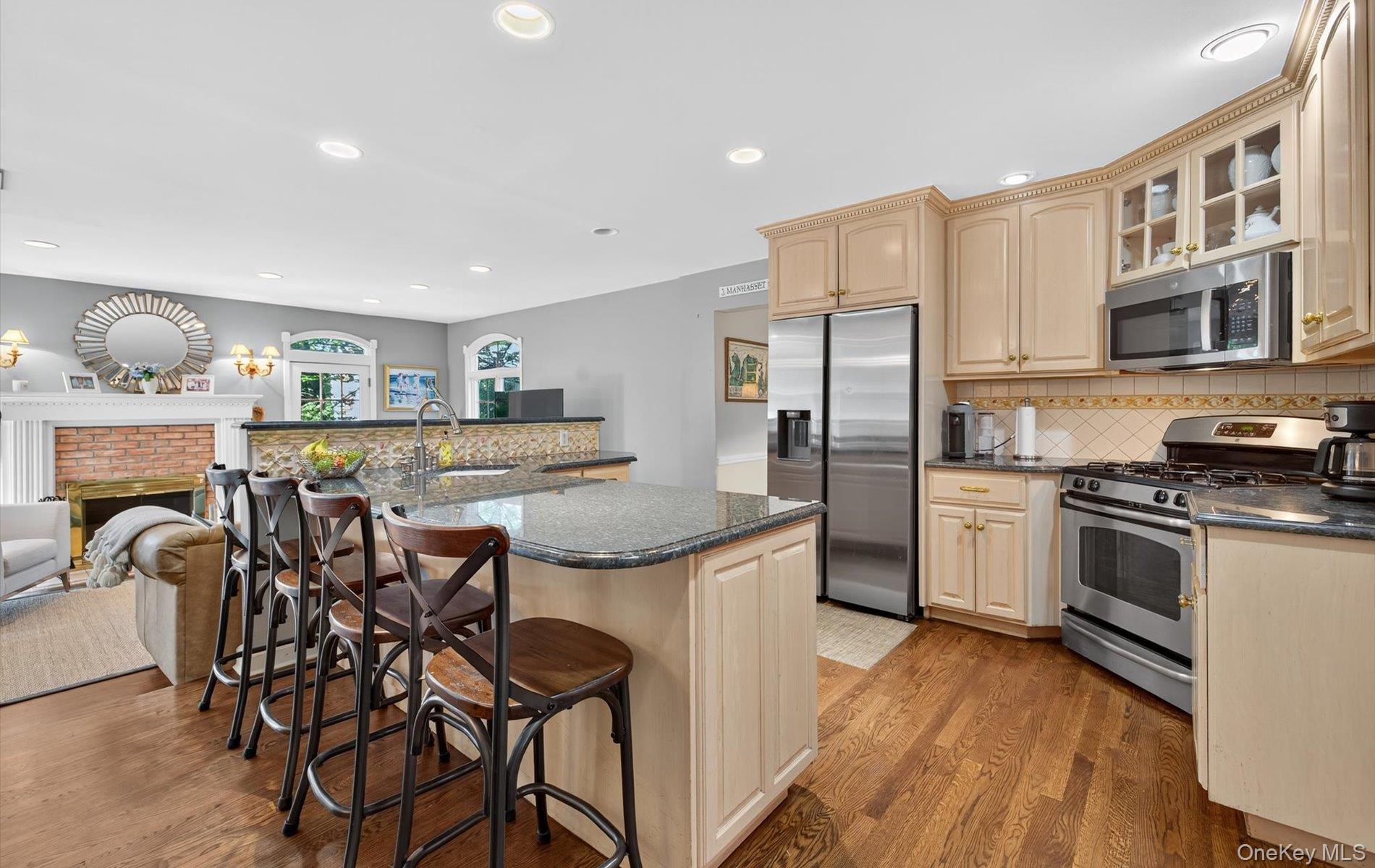 53 Eakins Road Manhasset, NY 11030 - Photo 9 of 34 a kitchen with stainless steel appliances granite countertop a stove and a refrigerator