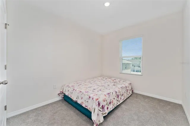 a bedroom with a bed and window