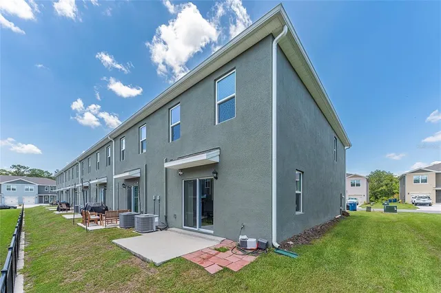 a view of an house with backyard porch and furniture