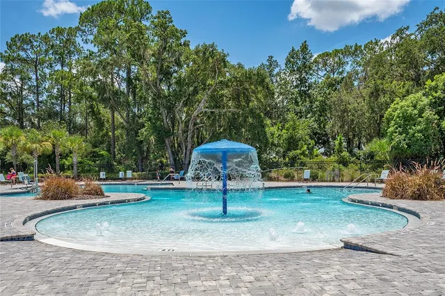 a swimming pool with trees in the background