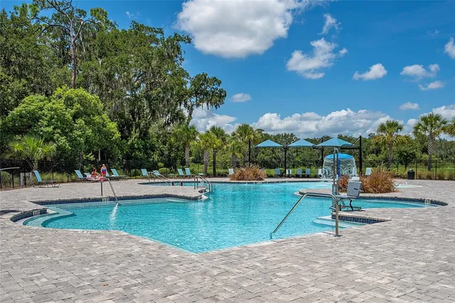 a view of a swimming pool with a yard