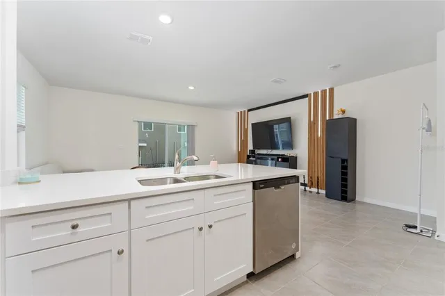 a kitchen with a sink and refrigerator