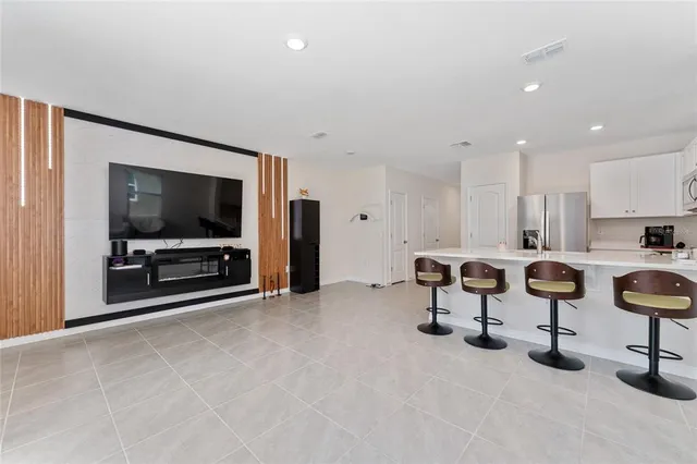 a view of a livingroom with furniture and a flat screen tv