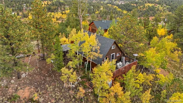 a very nice looking open dining room with kitchen island a stove a sink and a refrigerator