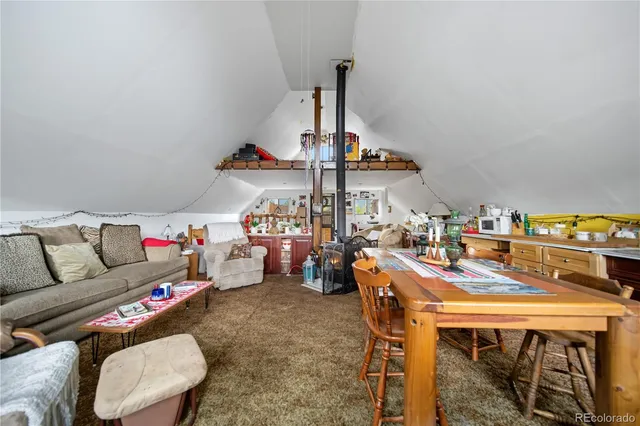 a view of a balcony with chairs and wooden floor