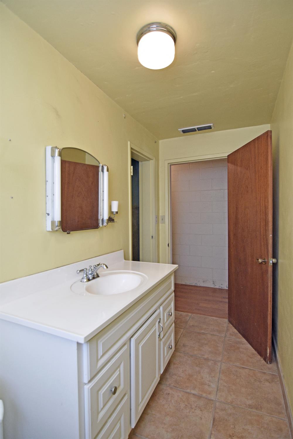 1206 South Verduga Road Turlock, CA 95380 - Photo 22 of 36 a bathroom with a sink and a mirror