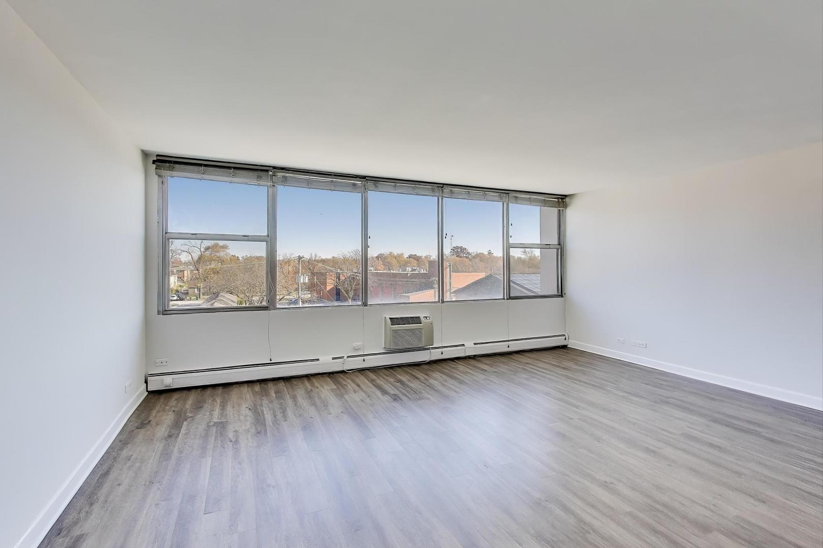 Undisclosed Address Lombard, IL 60148 - Photo 12 of 37 an empty room with wooden floor and windows