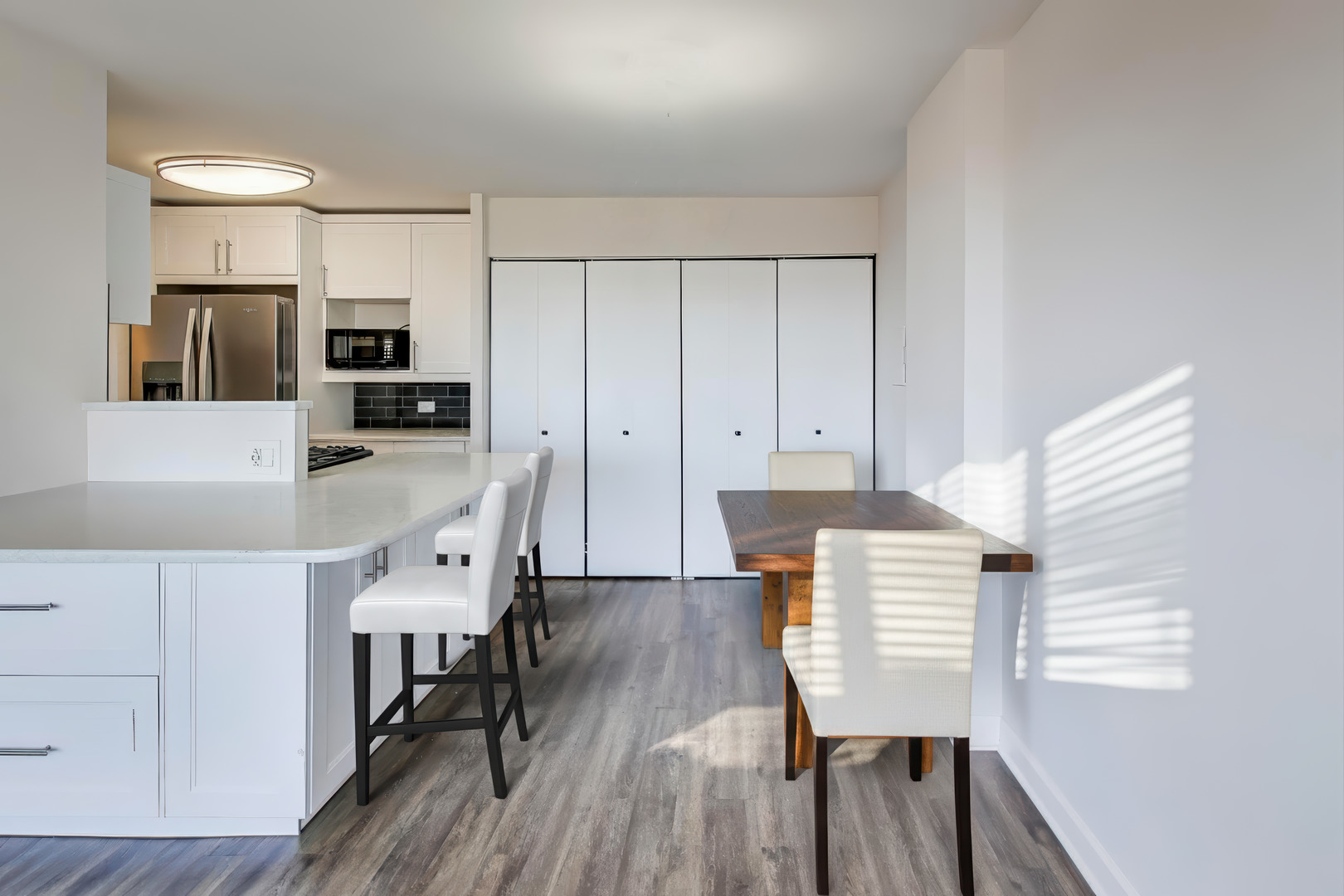 Undisclosed Address Lombard, IL 60148 - Photo 18 of 37 a kitchen with stainless steel appliances a table chairs microwave and sink
