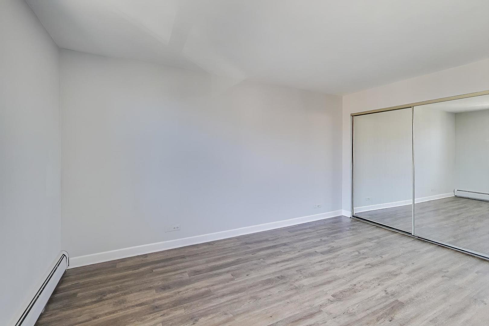 Undisclosed Address Lombard, IL 60148 - Photo 22 of 37 a view of an empty room with wooden floor