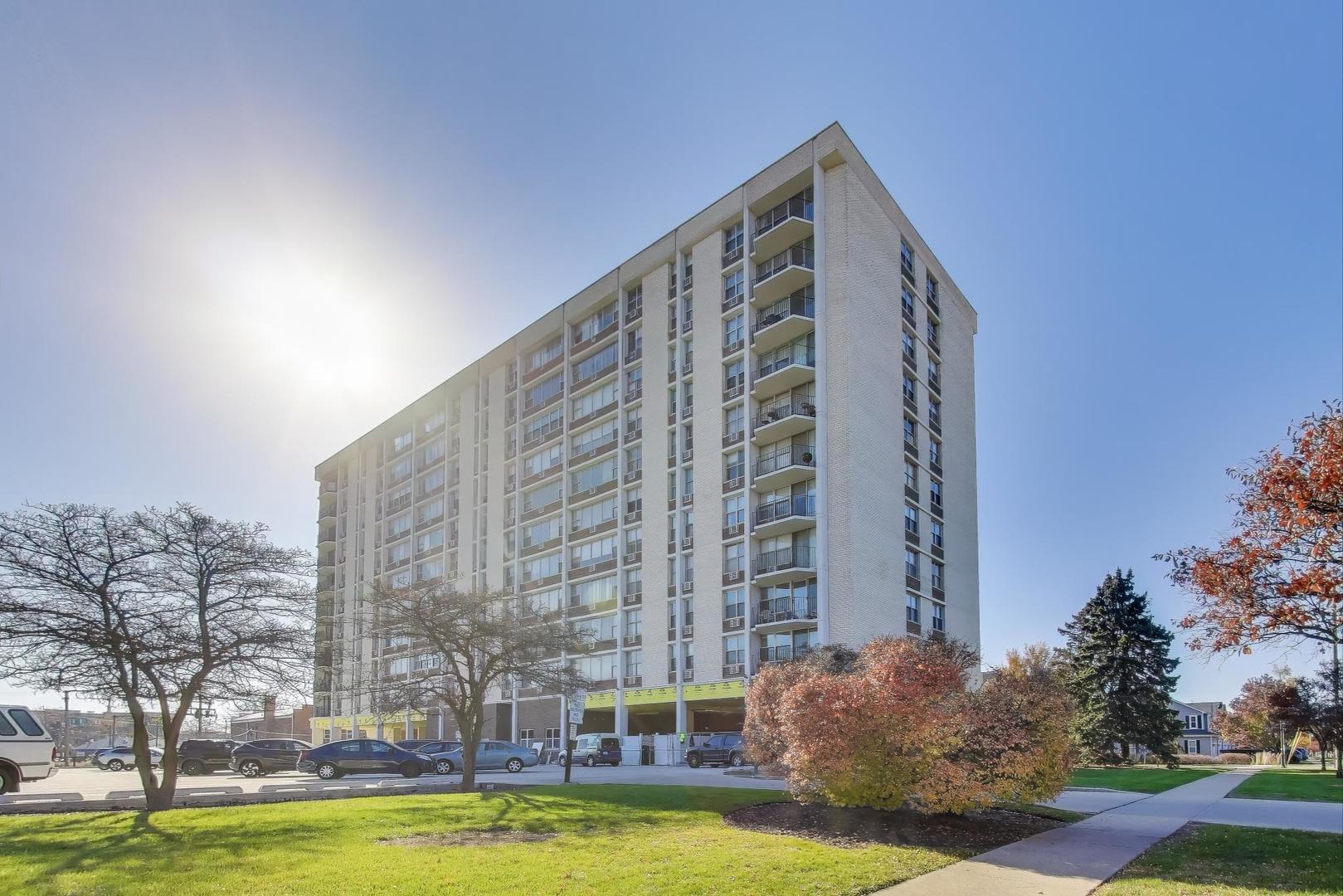 Undisclosed Address Lombard, IL 60148 - Photo 35 of 37 a front view of a building with large trees and plants