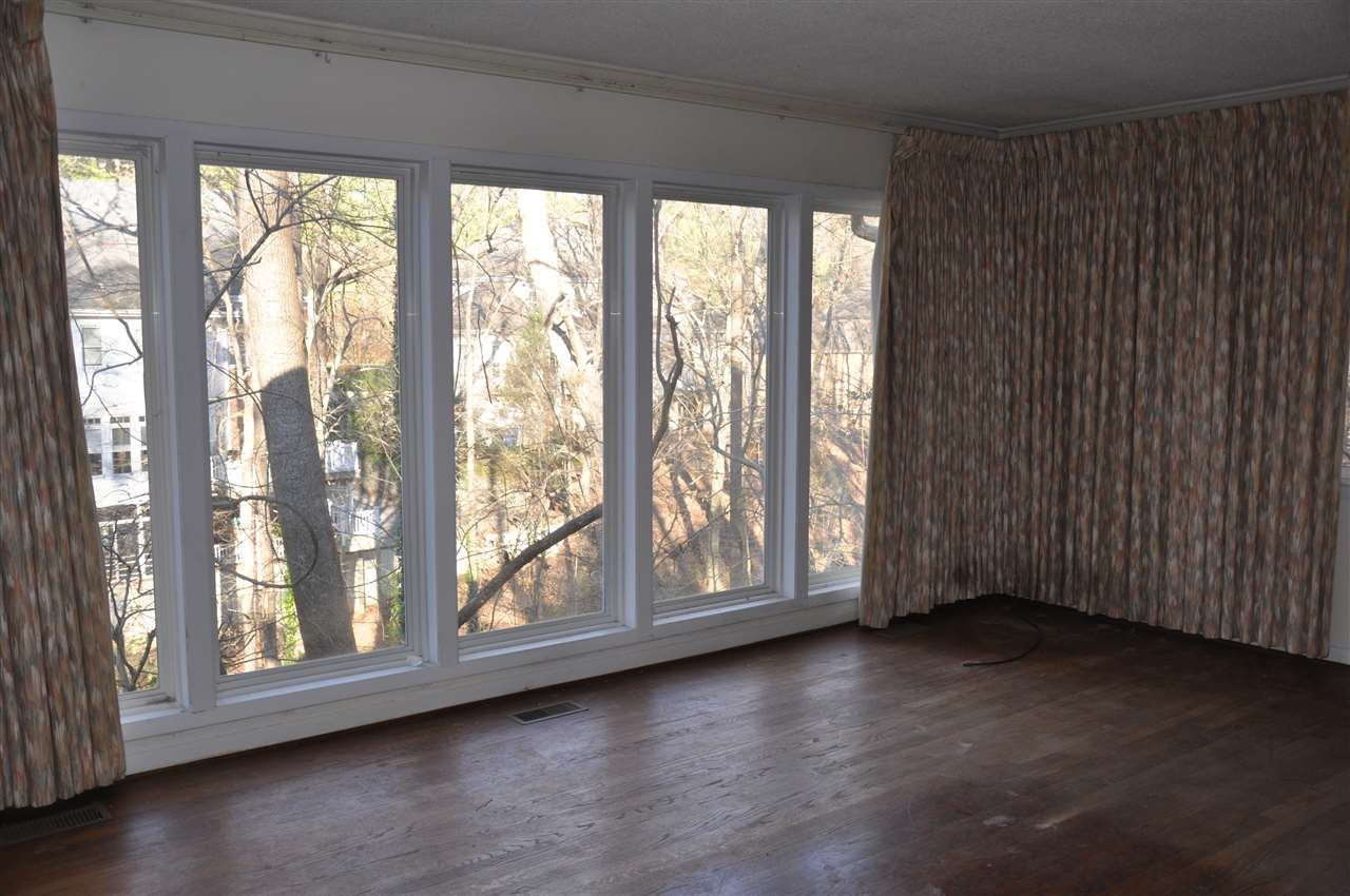 1200 Bancroft Street Raleigh, NC 27612 - Photo 13 of 16 Separated from the other three bedrooms by the length of the house!! Walls of windows offer a wonderful view. Master Bedroom