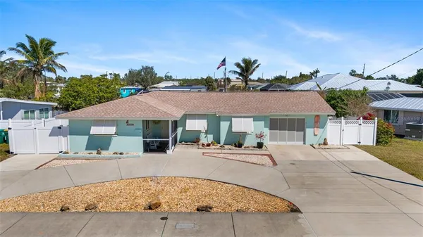 a patio with a table and chairs under an umbrella
