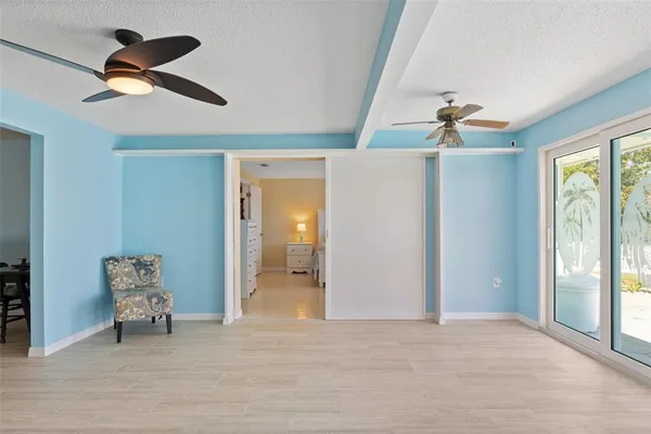 a view of a livingroom with a ceiling fan and window