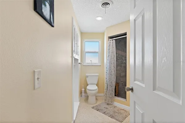a bathroom with a toilet and a shower