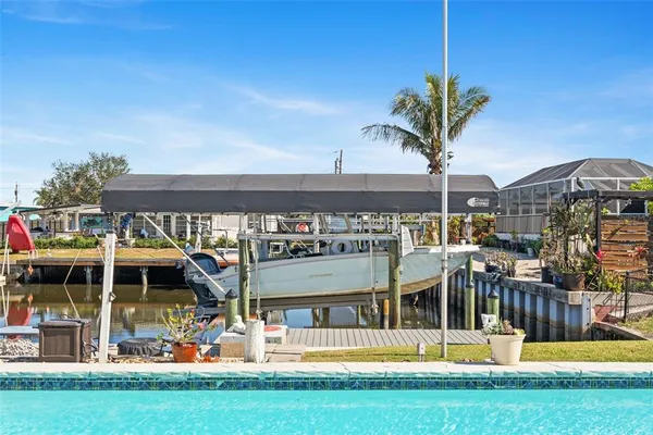 a view of a house with swimming pool and porch