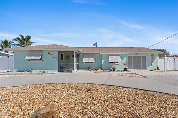 a front view of a house with a yard and a garage