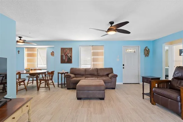 a living room with furniture and a dining table
