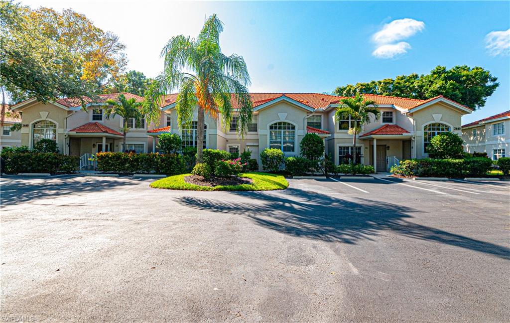 a view of a white house with a swimming pool