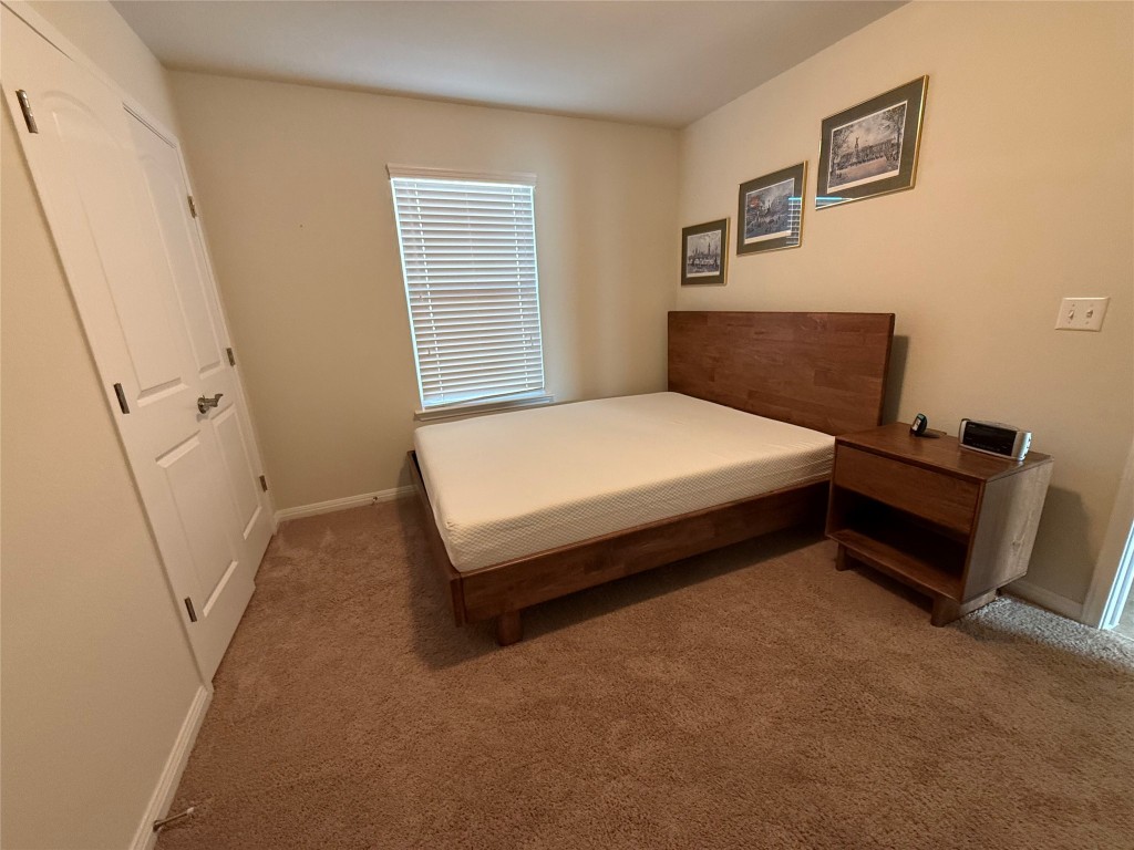 233 Hobby Street Georgetown, TX 78633 - Photo 4 of 13 a spacious bedroom with a bed and a dresser