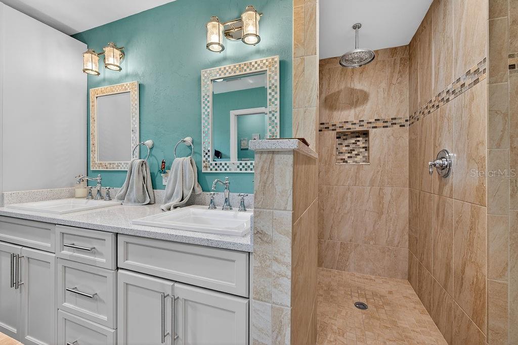 4719 Dixie Drive Ponce Inlet, FL 32127 - Photo 12 of 20 a bathroom with a sink vanity granite shower and a mirror