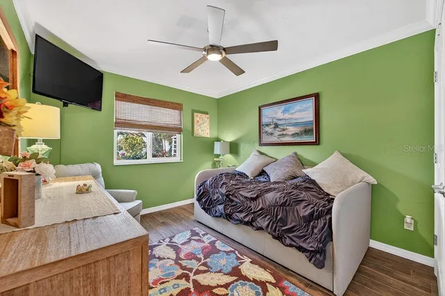a bed room with a bed window and a flat screen tv