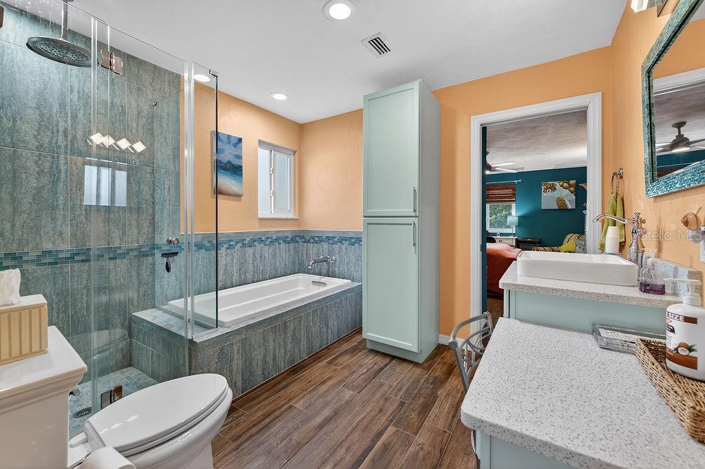 4719 Dixie Drive Ponce Inlet, FL 32127 - Photo 14 of 20 a bathroom with a sink a toilet a mirror and bathtub