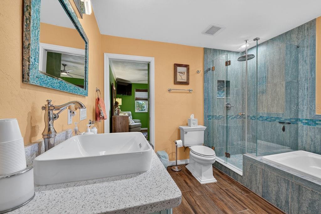 4719 Dixie Drive Ponce Inlet, FL 32127 - Photo 15 of 20 a bathroom with a bathtub shower sink mirror and toilet