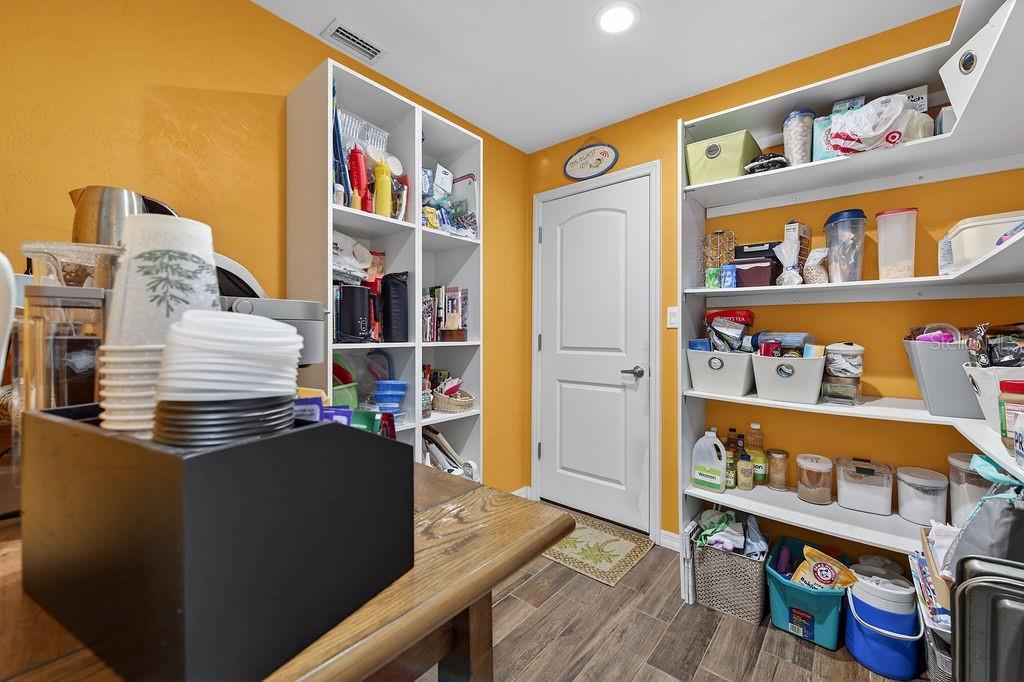 4719 Dixie Drive Ponce Inlet, FL 32127 - Photo 18 of 20 a room with furniture a rug and a book shelf
