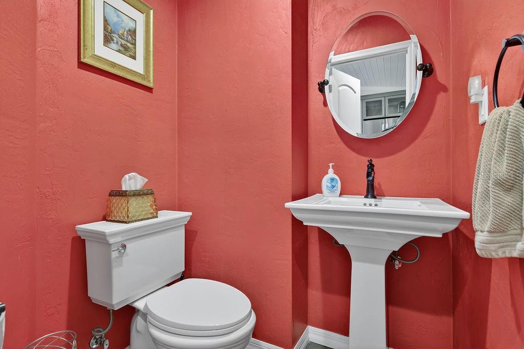 4719 Dixie Drive Ponce Inlet, FL 32127 - Photo 19 of 20 a bathroom with a toilet a sink and a mirror