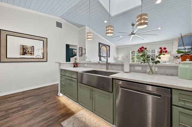 a kitchen with stainless steel appliances granite countertop a sink and a microwave