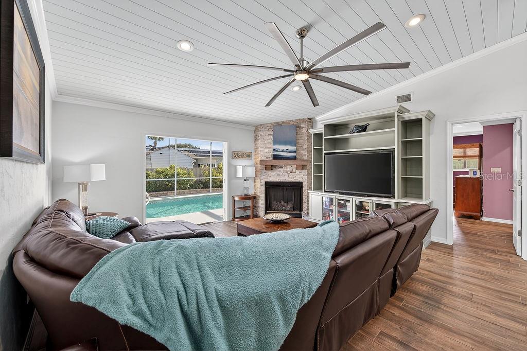 4719 Dixie Drive Ponce Inlet, FL 32127 - Photo 7 of 20 a living room with furniture a flat screen tv and a fireplace