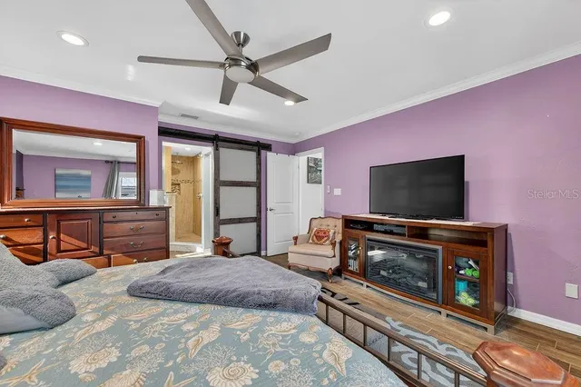 a bedroom with furniture and a flat screen tv