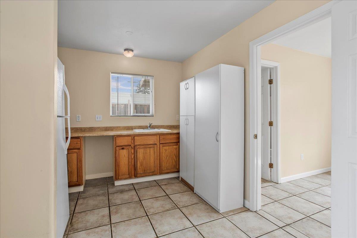 7449 Alexander Street Gilroy, CA 95020 - Photo 16 of 18 a kitchen with a refrigerator and a sink