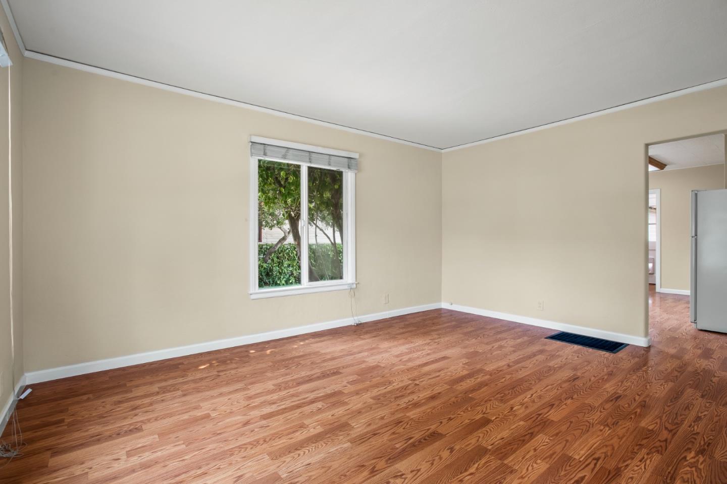 7449 Alexander Street Gilroy, CA 95020 - Photo 3 of 18 a view of an empty room with wooden floor and a window