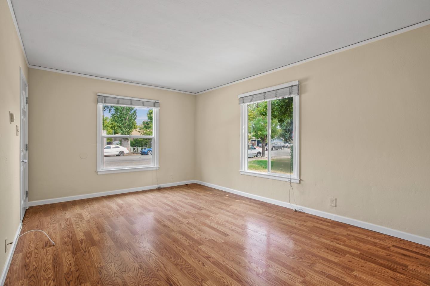 7449 Alexander Street Gilroy, CA 95020 - Photo 4 of 18 a view of an empty room with wooden floor and a window