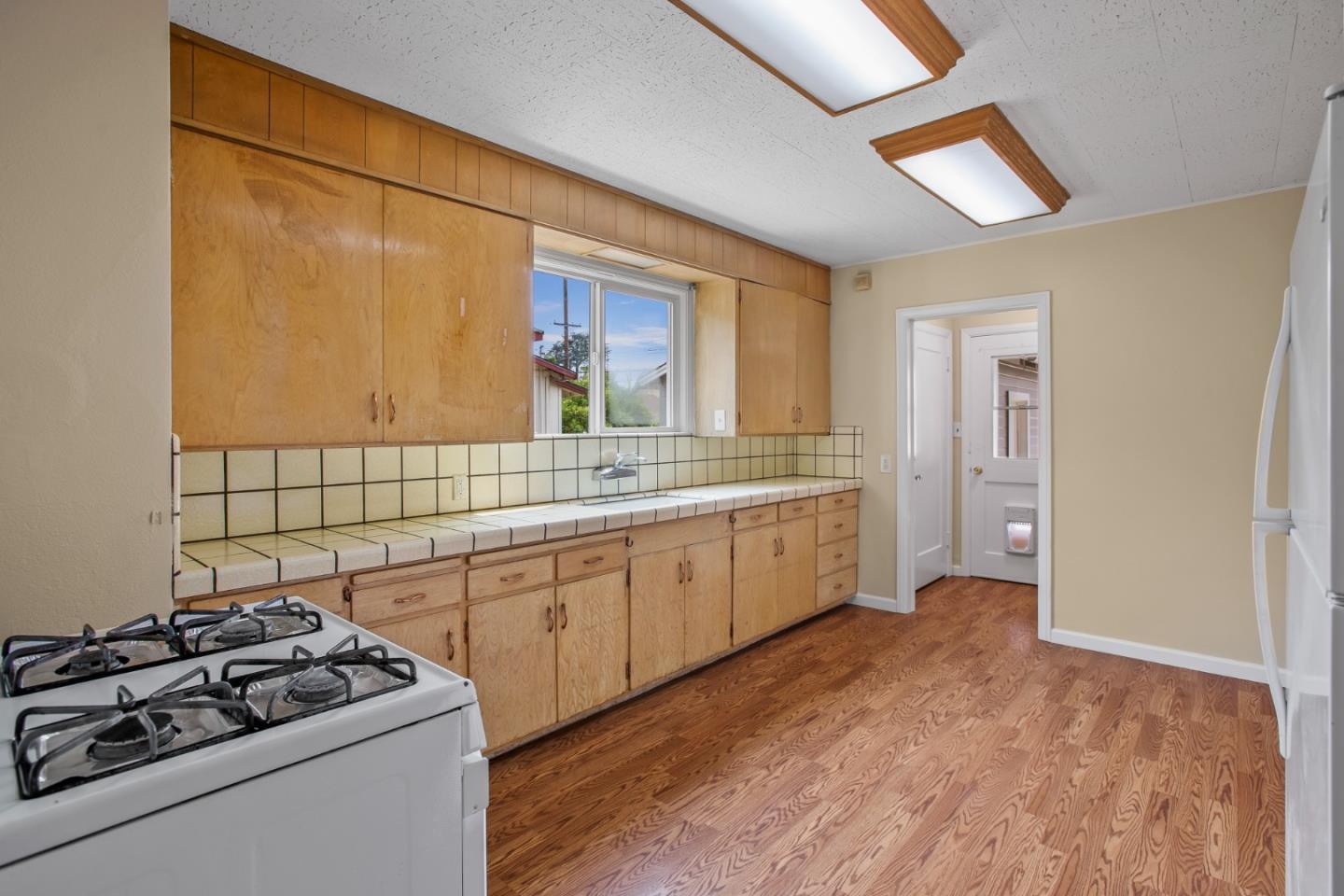 7449 Alexander Street Gilroy, CA 95020 - Photo 6 of 18 a kitchen with a sink stove and cabinets