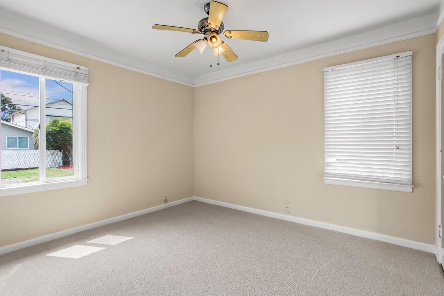 7449 Alexander Street Gilroy, CA 95020 - Photo 9 of 18 an empty room with a window and a ceiling fan