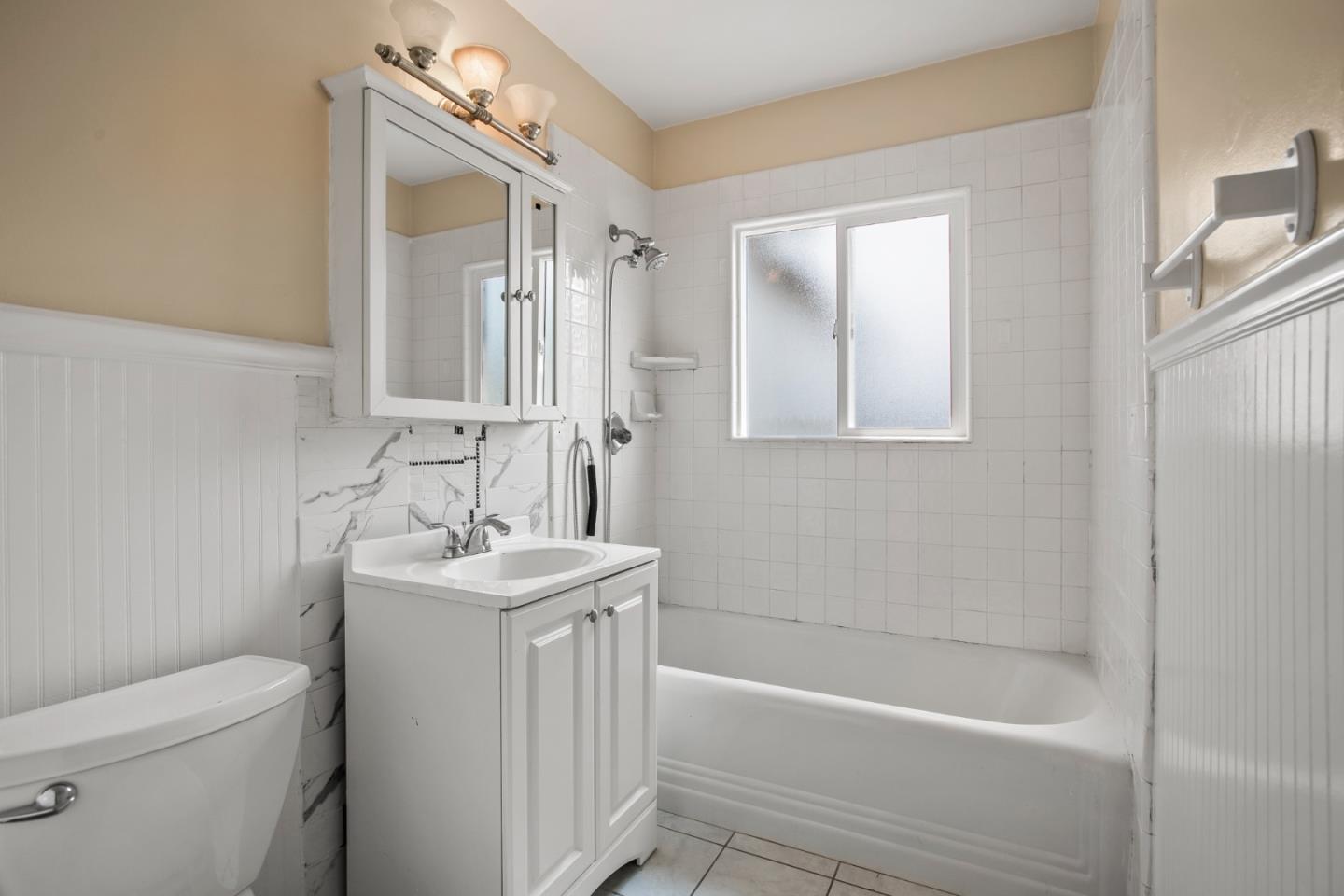 7449 Alexander Street Gilroy, CA 95020 - Photo 10 of 18 a bathroom with a sink a toilet and shower