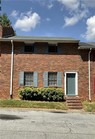 a front view of a house with garage and yard