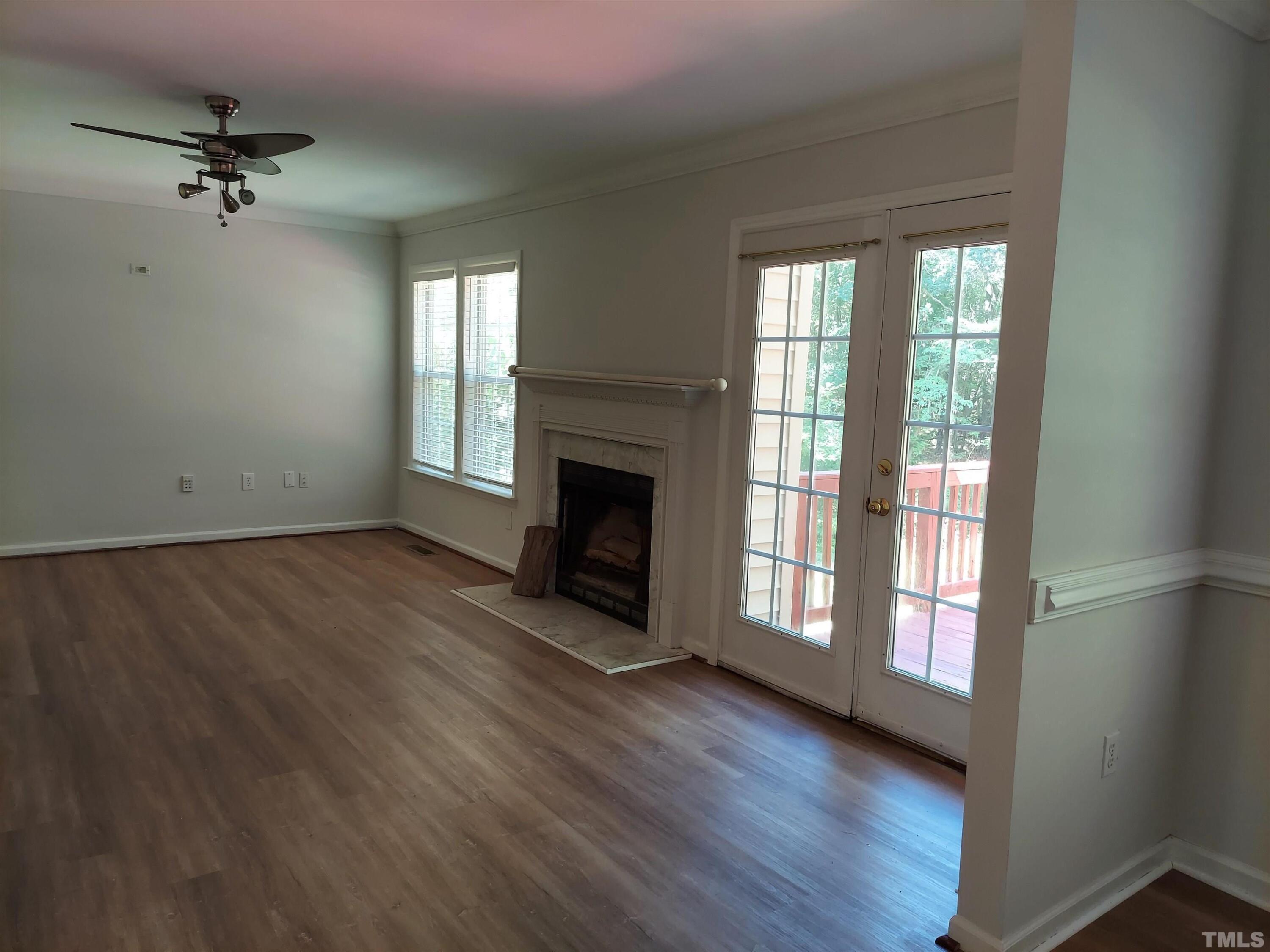 224 Crossfire Road Holly Springs, NC 27540 - Photo 10 of 43 a view of an empty room with a window and wooden floor