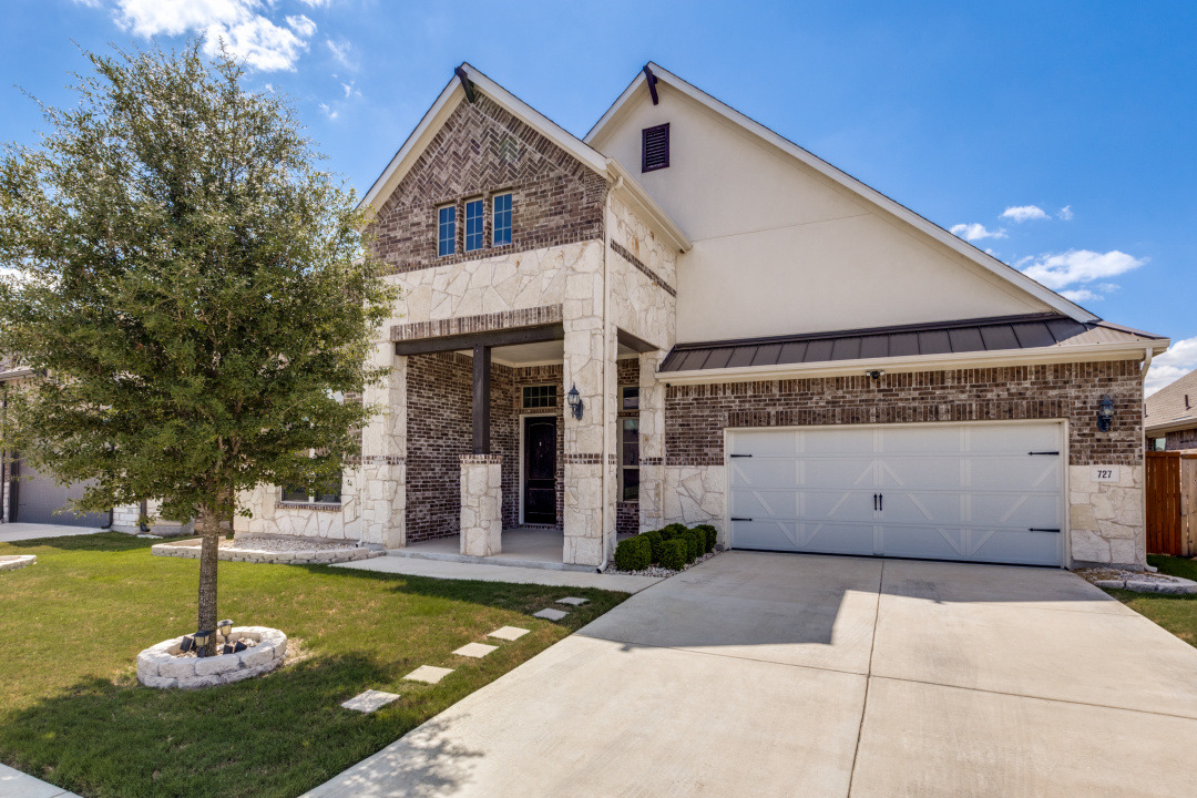 727 Spinnaker Loop Kyle, TX 78640 - Photo 2 of 29 Striking brick and stone masonry defines this modern exterior with a prominent two-car garage.