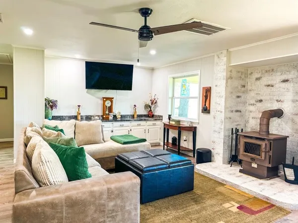 a living room with fireplace furniture and a flat screen tv
