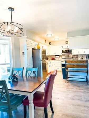 a dining table with chairs and window