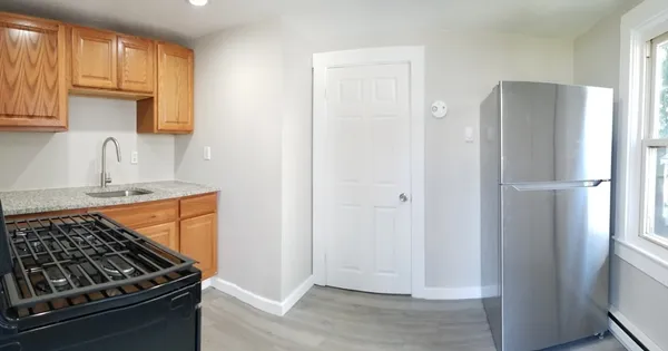 a kitchen with wooden cabinets and a stove top oven