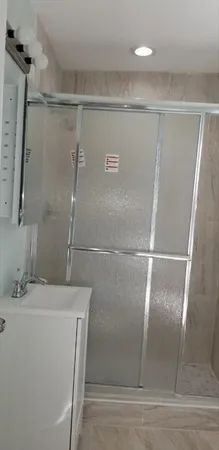 a bathroom with a shower and a sink