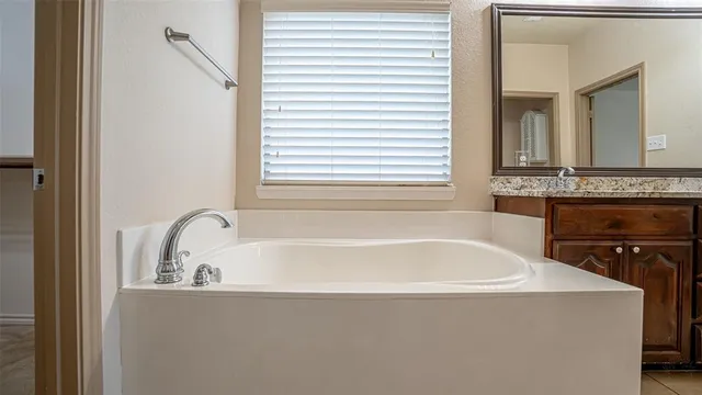 a bathroom with a tub and a sink
