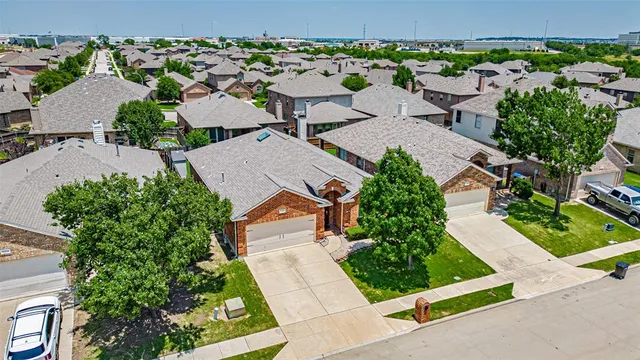 an aerial view of a house with garden space and street view